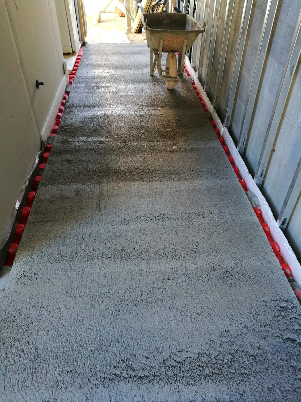 The same hallway with the screed poured during the Casa Llucmajor build, an installation by JSL in Mallorca