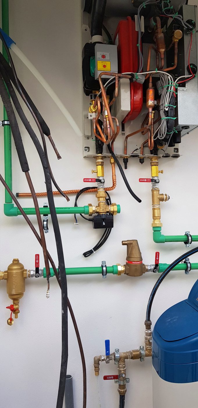 Open heat-pump indoor unit during plant-room assembly in the Casa Llucmajor build, an installation by JSL in Mallorca