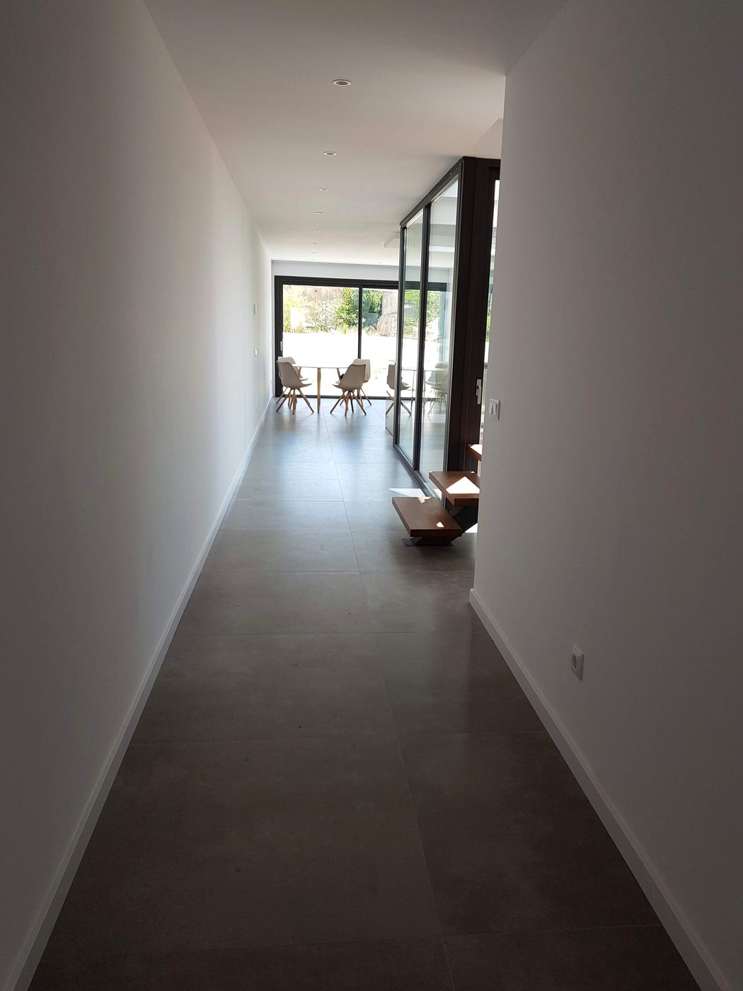 Finished open-plan living space towards the window after the Casa Llucmajor build, an installation by JSL in Mallorca