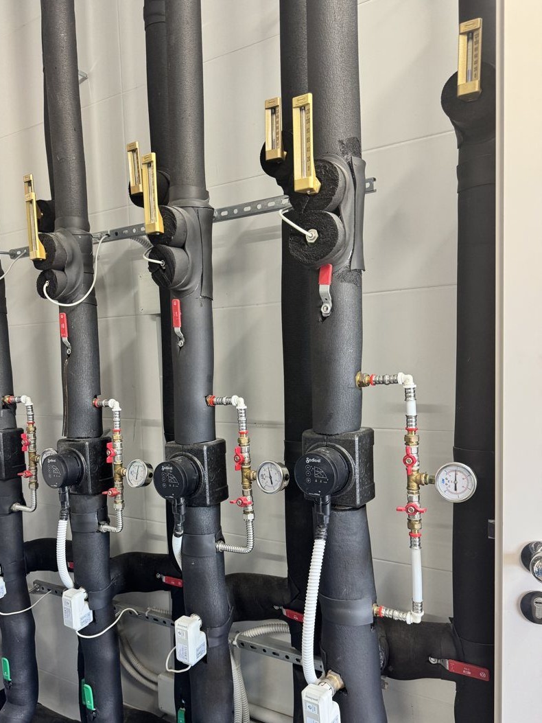 Insulated manifolds, circulation pumps and valves in a plant room installed by JSL in Mallorca