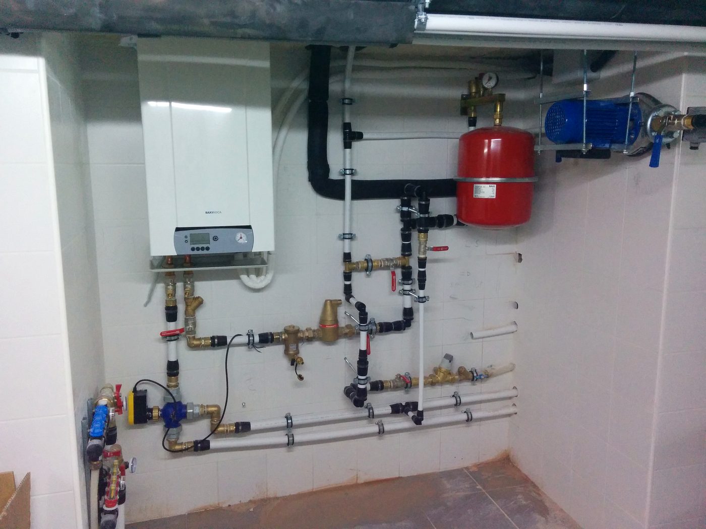 Plant room with boiler, pressure group and aligned pipework built by JSL in Mallorca